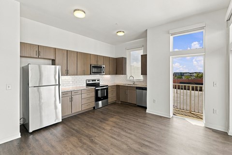A kitchen with a white refrigerator and wooden cabinets.