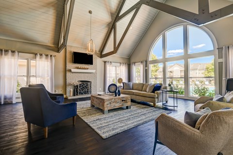 A living room with a blue chair and a brown couch.