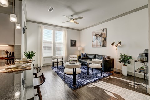 A modern living room with a dining table and chairs.