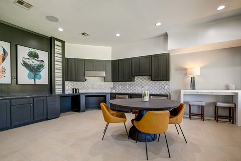 A modern kitchen with a dining table and chairs.