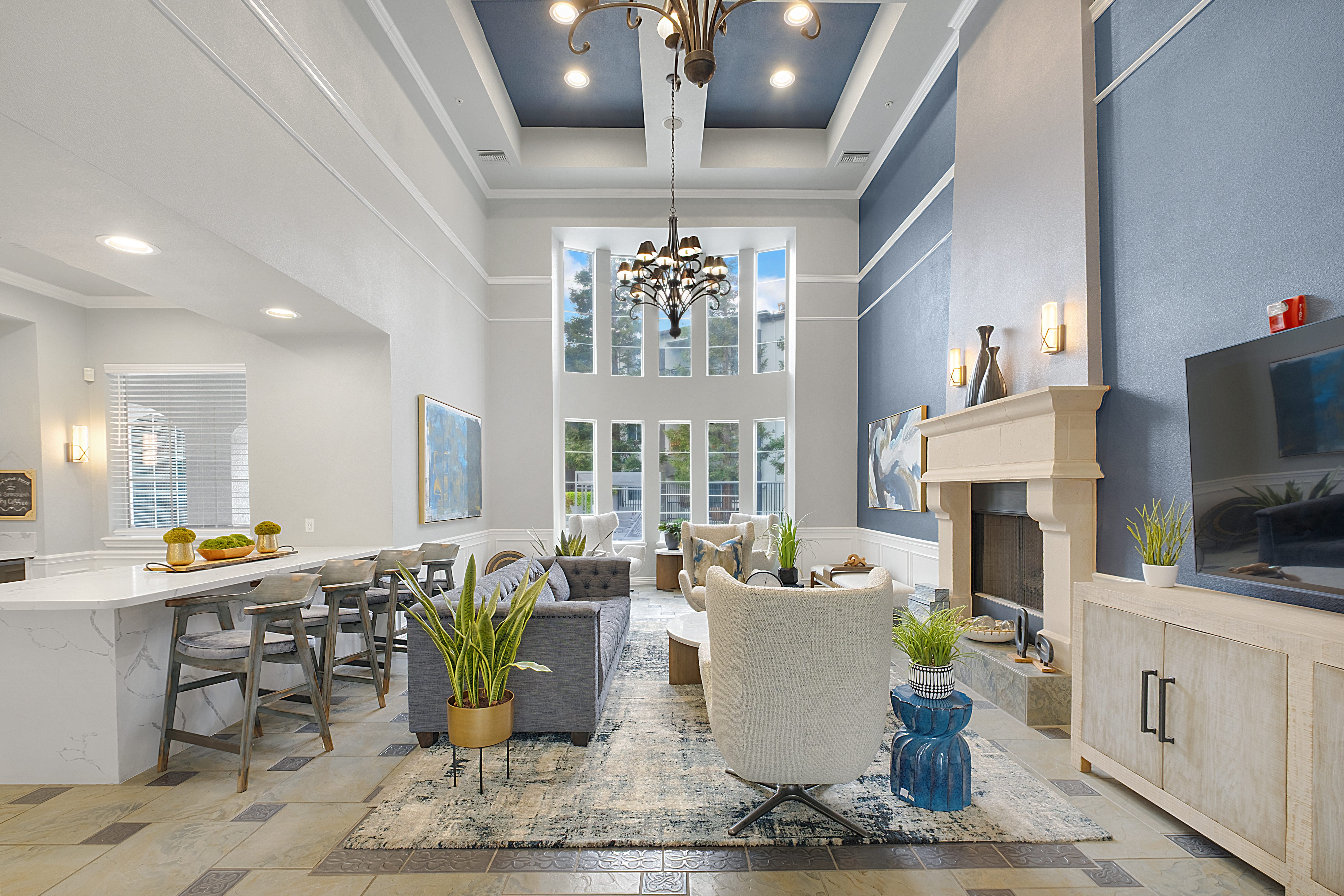 A well-lit, spacious living room with a fireplace and a dining area.