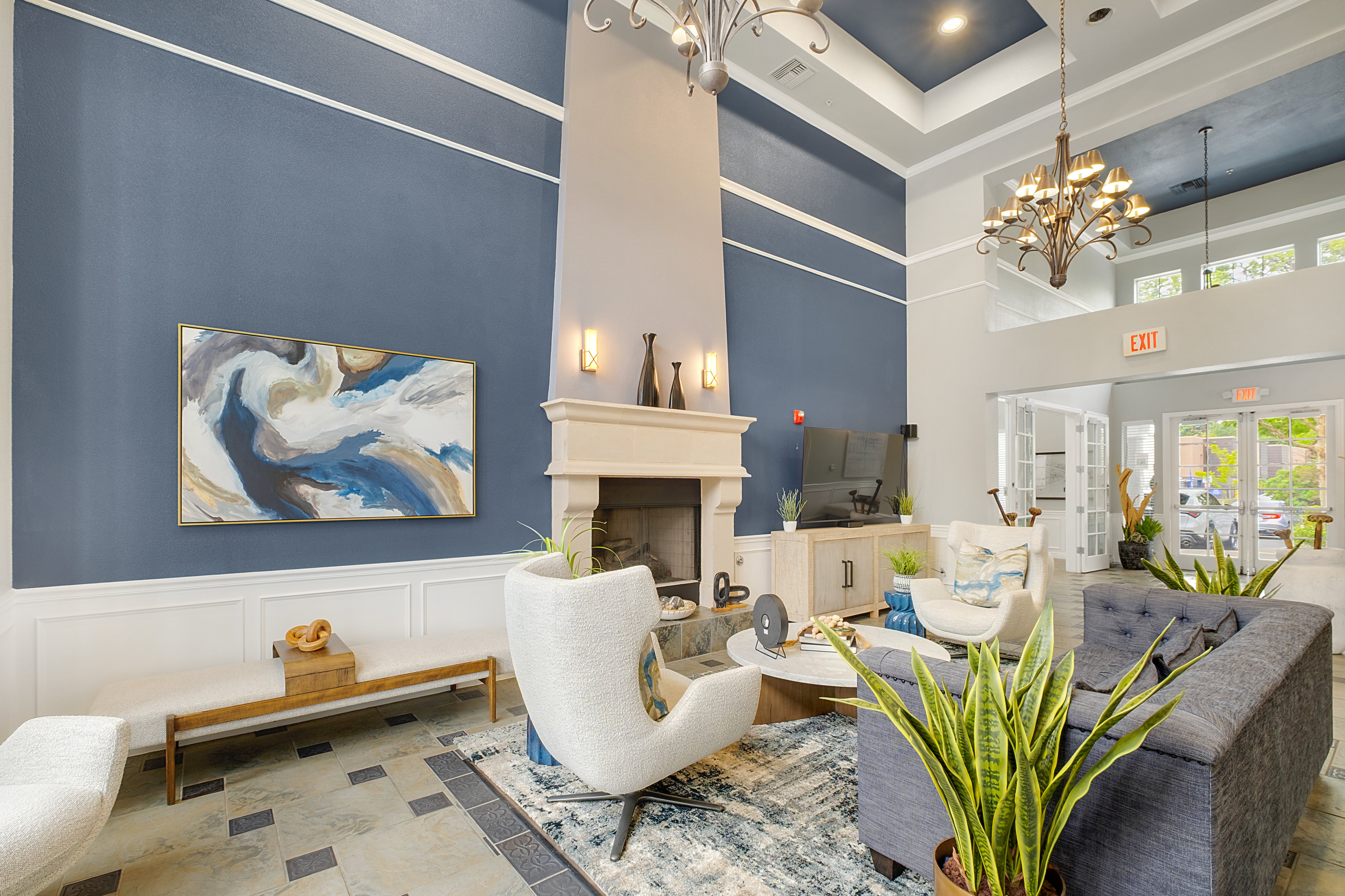 A living room with a fireplace and a painting on the wall.