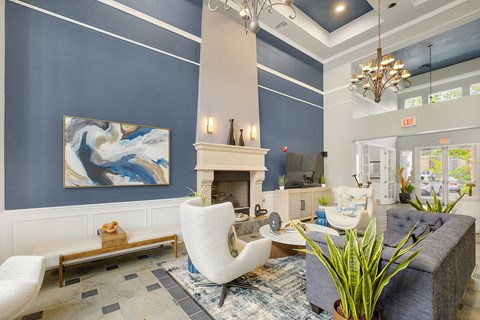 A living room with a fireplace and a painting on the wall.