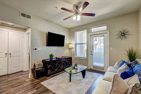 A living room with a brown coffee table and a white couch.