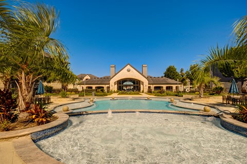 A large house with a pool in the front yard.