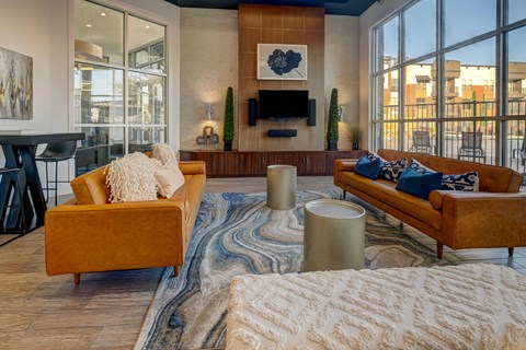 A living room with a yellow couch and a white sofa.