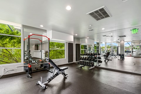 A gym with a variety of equipment including a leg press machine.
