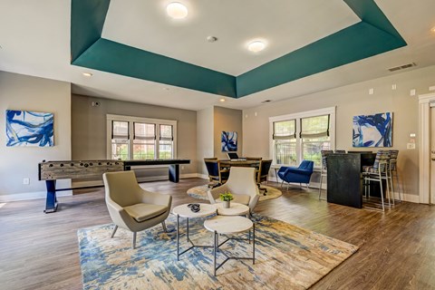 A living room with a pool table and a dining table.