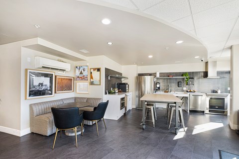 A modern kitchen with a dining table and chairs.