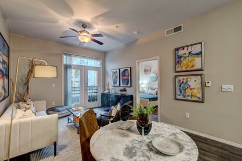 A living room with a white couch and a ceiling fan.