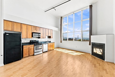 A kitchen with black appliances and wooden cabinets.