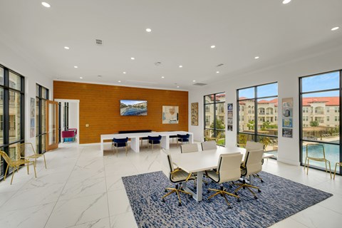 A large room with a long table and chairs.