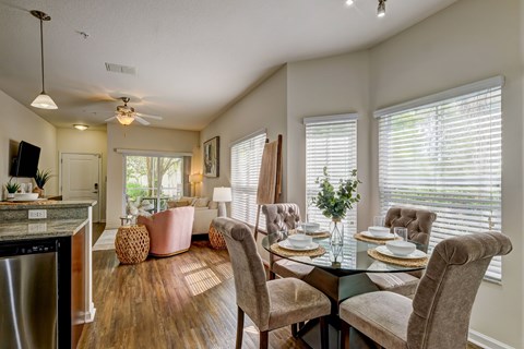 A dining room with a table set for four.