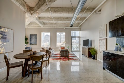 A dining room with a table and chairs.