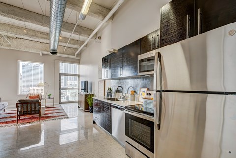 A modern kitchen with stainless steel appliances and a large island.
