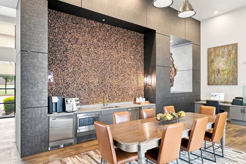 A modern kitchen with a wooden table and chairs.