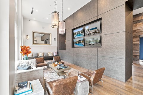 A modern living room with a large mirror, a sofa set, and a television displaying a poolside scene.