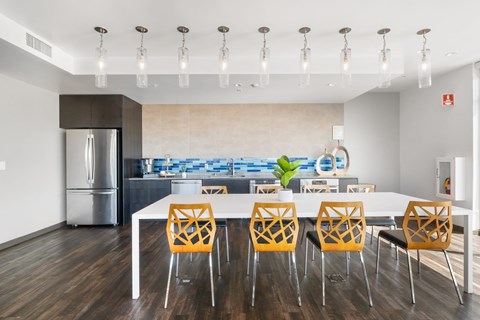 A modern kitchen with a dining table and chairs.