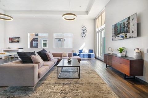A modern living room with a large couch and a coffee table.