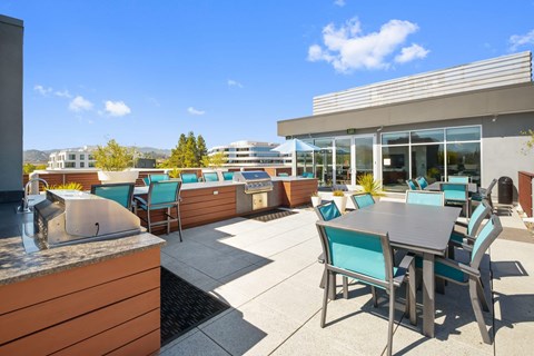 A patio with a table and chairs is surrounded by buildings.