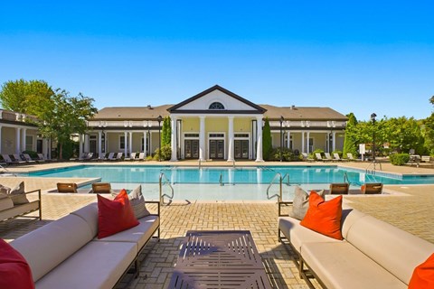 A large house with a pool in front.