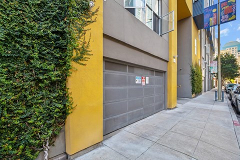 A yellow garage door with a sign on it.