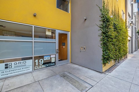 A yellow building with a sign that says "GRID" on the window.