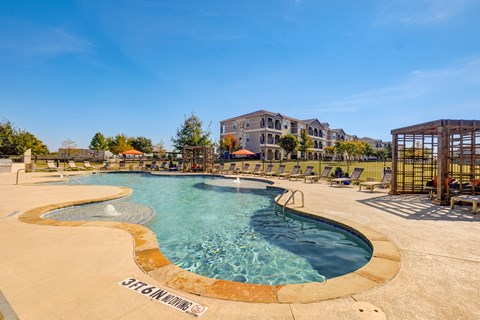 A large outdoor swimming pool with a sign that says "STEAMBOAT".