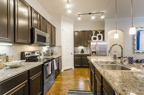 a kitchen with stainless steel appliances and granite counter tops
