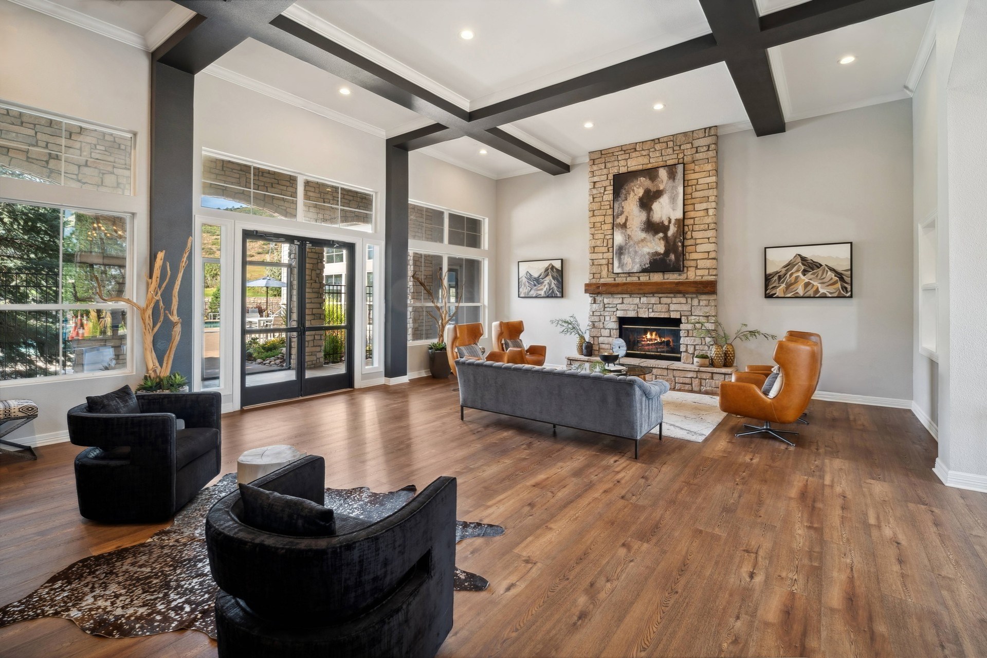 A living room with a fireplace and a painting on the wall.