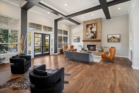 A living room with a fireplace and a painting on the wall.