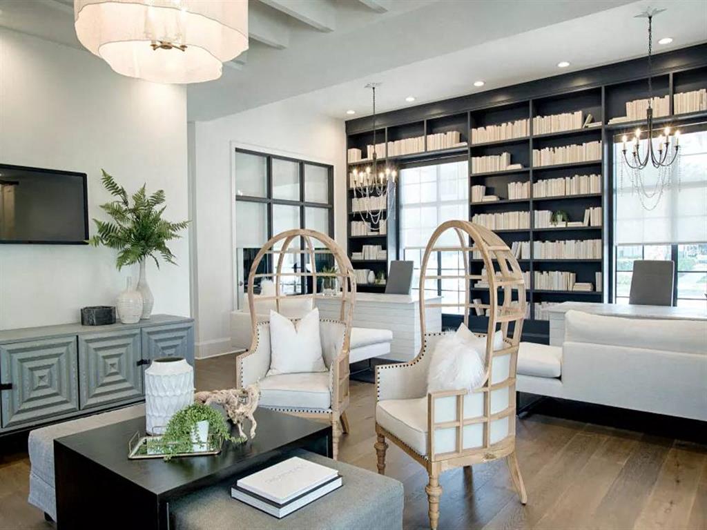 a living room filled with furniture and a book shelf