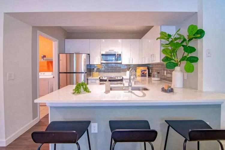 Chef's Kitchen with Stainless Appliances & Prep Island at The Sophia at Abacoa, Jupiter, FL