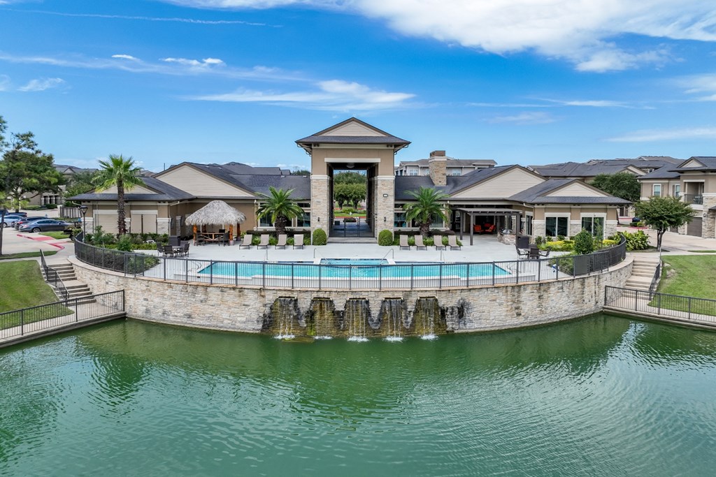 lakeside swimming pool at The Falls at Copper Lake Houston apartments