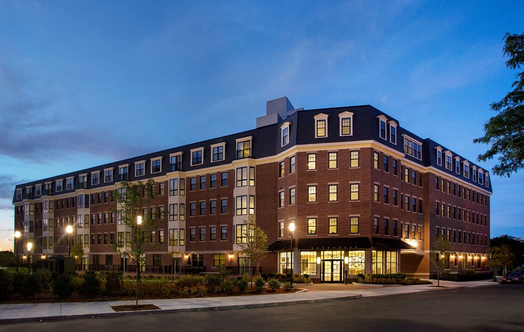 Exterior 5-Story Building at Dusk with Beautiful Controlled Access Entrance and Garage Parking Entrance at Gatehouse 75, Charlestown, Massachusetts
