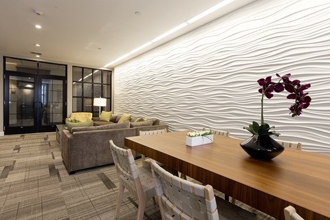 A modern dining room with a wooden table and chairs.