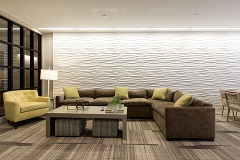 A modern living room with a large sectional sofa and a coffee table.