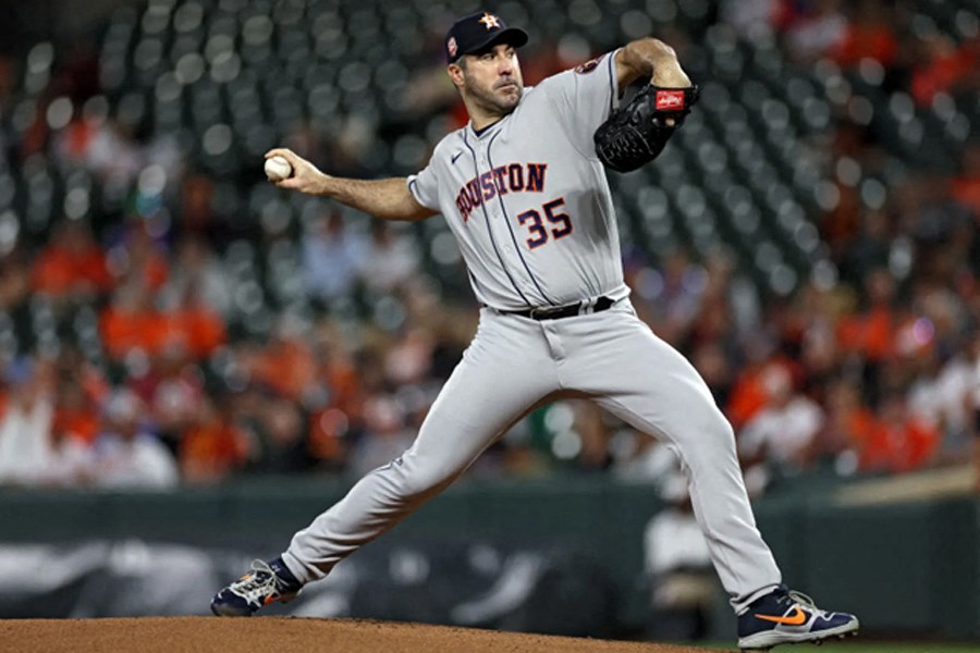 baseball player throws a pitch during a game