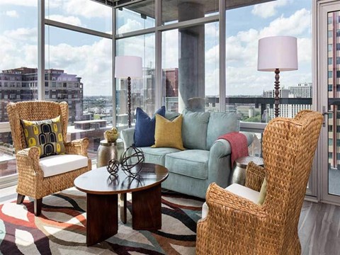 a living room with a couch and a table in front of a window