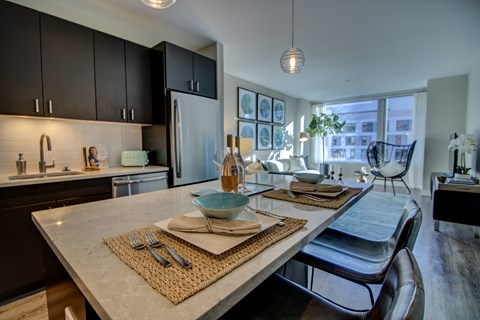 an open kitchen and dining room with a table and chairs