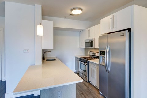 a kitchen with stainless steel appliances and white cabinets