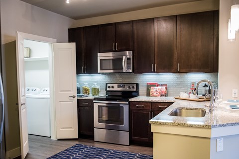 A kitchen with brown cabinets and a white refrigerator.