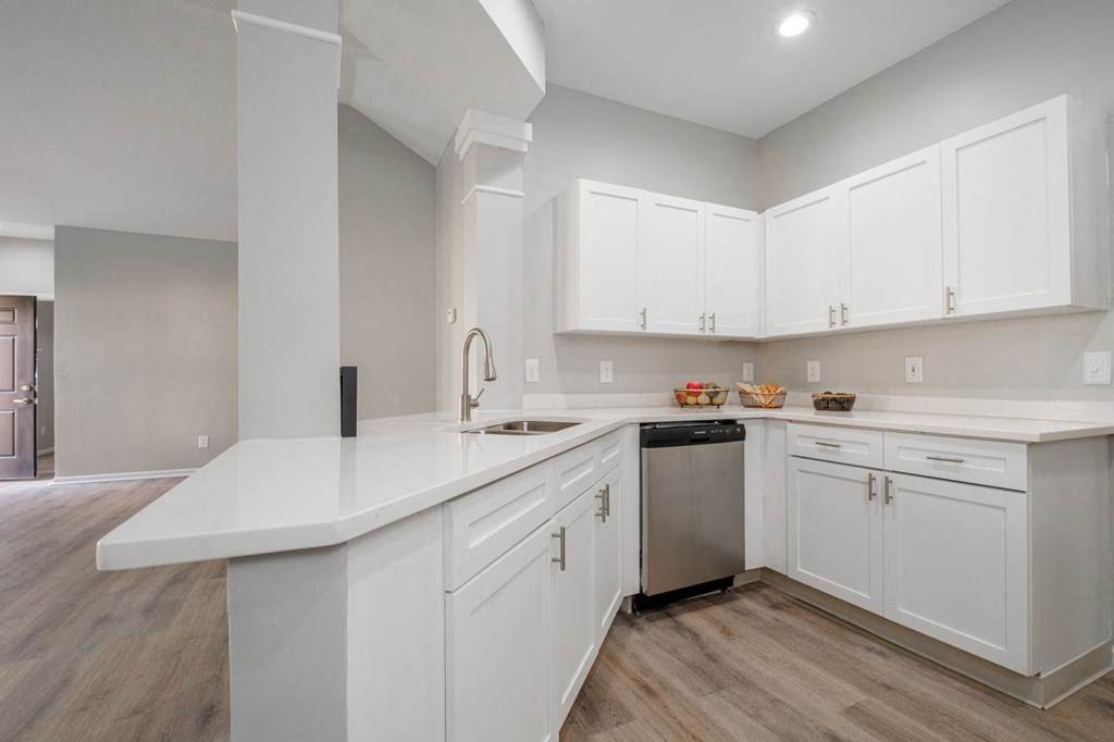 Kensington Grove apartments large white kitchen with white cabinets and a stainless steel dishwasher