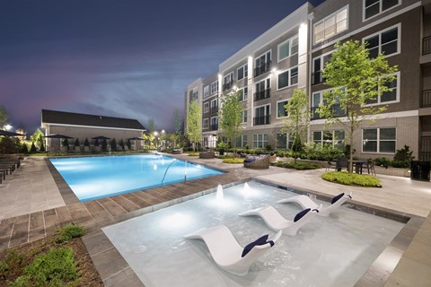 A swimming pool with a slide in the middle of it.