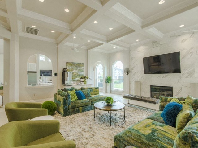 Club Room With Large Screen Tvs And A Fireplace at Berkshire Woodland, Conroe, TX