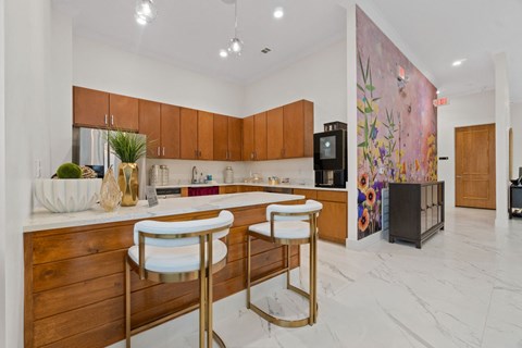 a kitchen with wooden cabinets and a counter with three stools