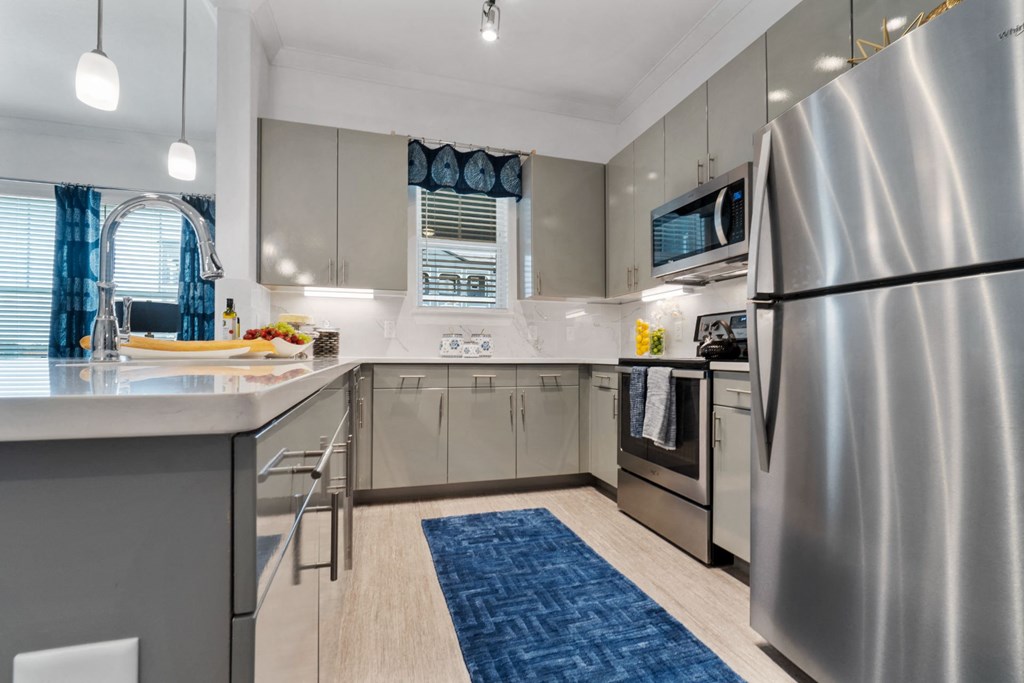Kitchen with appliances at Reveal on the Lake, Rowlett