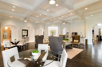 Lounge interior with sofas and table chair at Villages of Magnolia, Texas - Photo Gallery 49
