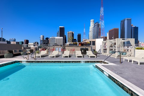 A swimming pool with a view of the city skyline.
