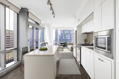 A modern kitchen with white cabinets and a large island.